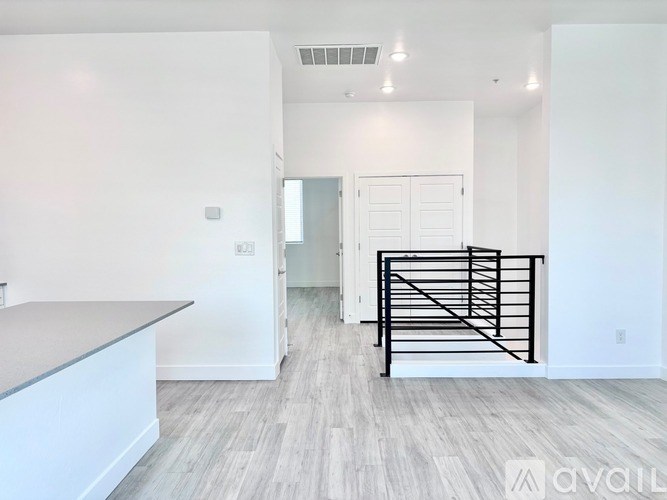 A spacious room with a staircase and a counter.