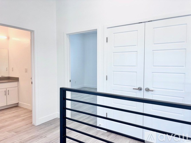 A white door is in the middle of a hallway.