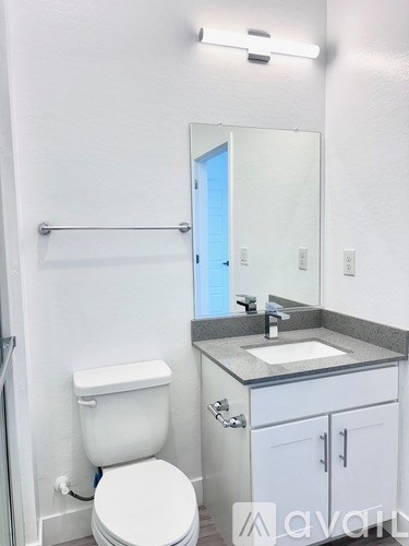 A white toilet sits next to a sink in a bathroom.