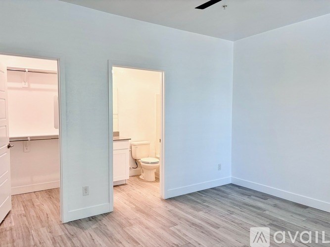 A room with a toilet and a door leading to another room.