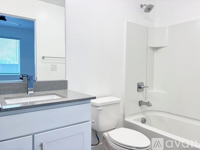 A white toilet sits next to a sink in a bathroom.