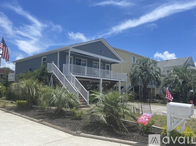 A house with a porch and a flag on it.