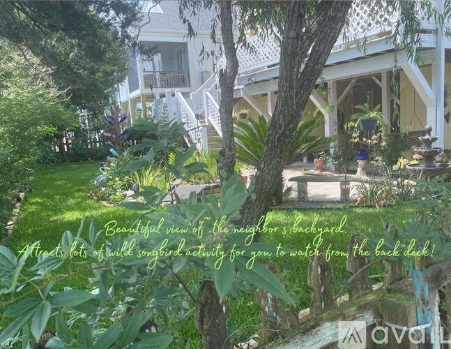 A beautiful view of the neighbor's backyard with a tree in the foreground.