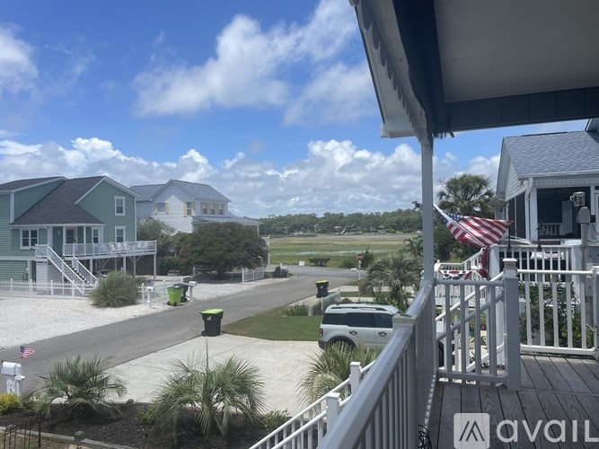 A street view of a residential area with houses on both sides.