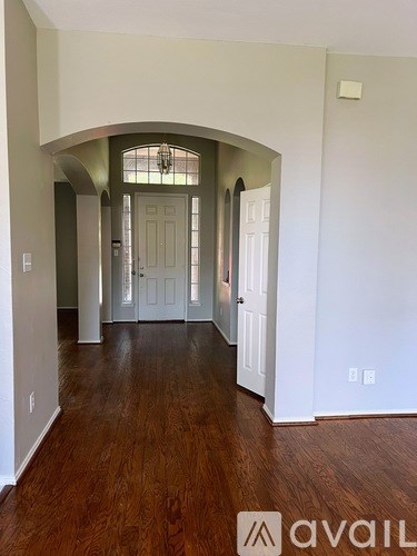 A room with wooden floors and a white door.