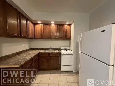 A kitchen with wooden cabinets and a granite countertop.