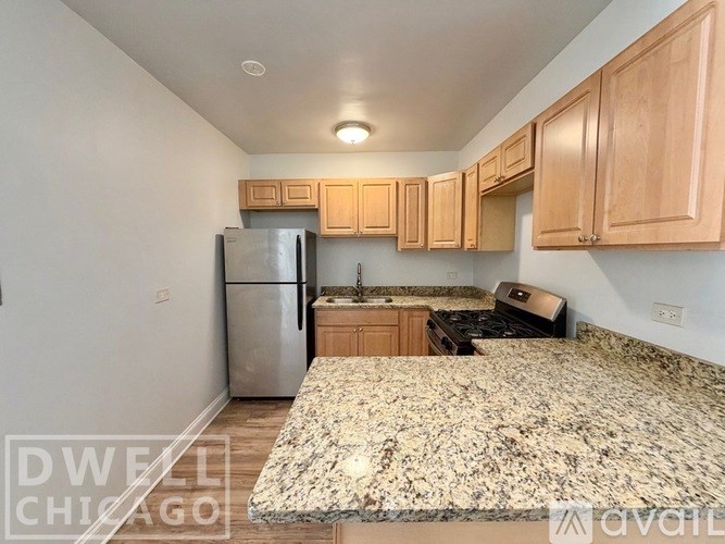 A room with wooden flooring and a window.