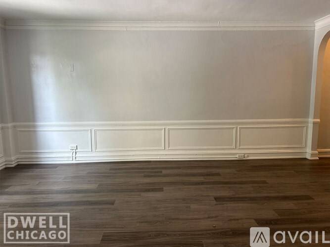 A kitchen with a white refrigerator and white cabinets.