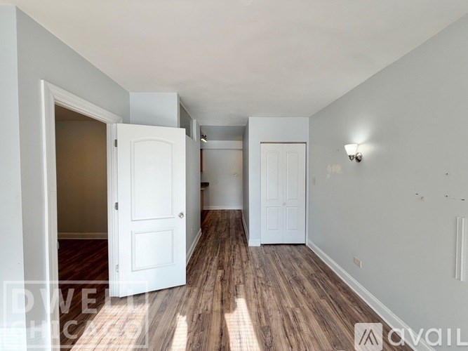 A white cupboard with a mirror and drawers is shown.