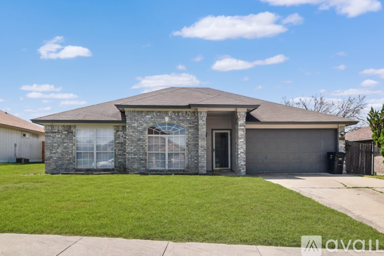 A house with a grey roof and a garage door.