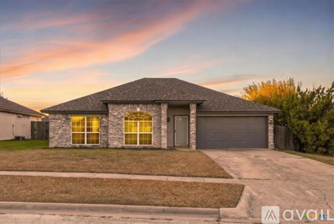 A house with a grey roof and a garage door.