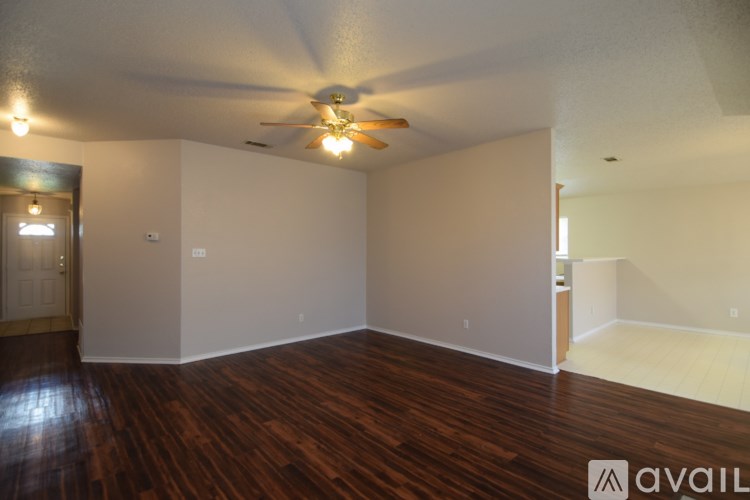 A room with wooden floors and a ceiling fan.