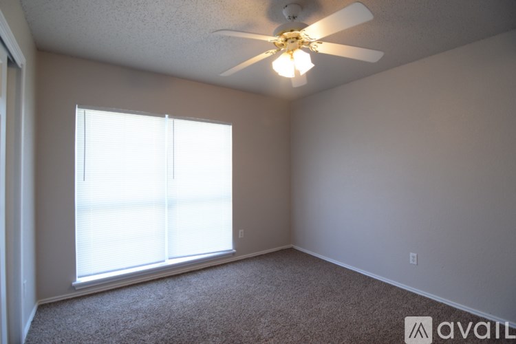 A room with a fireplace and wood flooring.