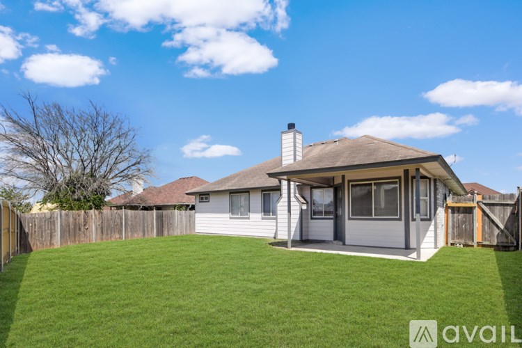 A house with a fence and a grassy yard.