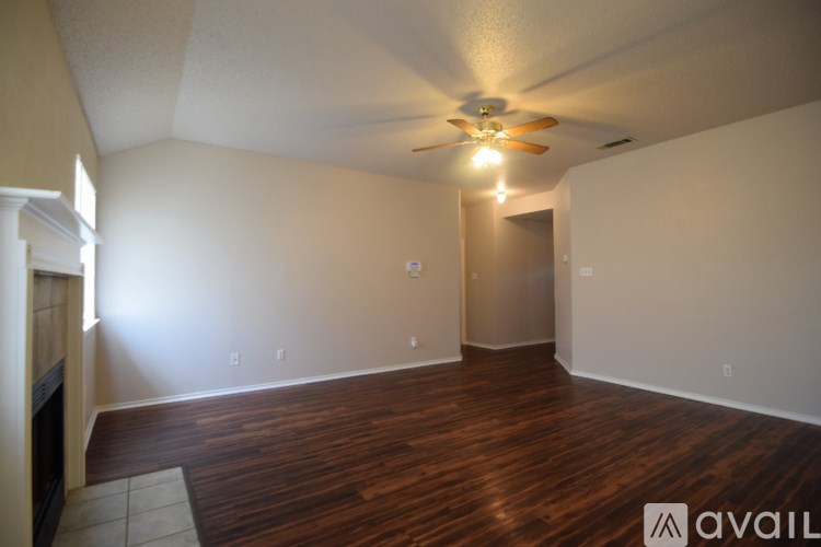 A room with a fireplace and a ceiling fan.