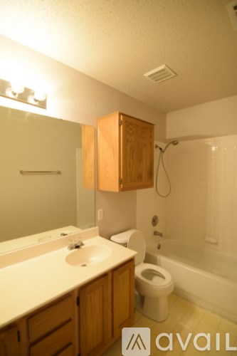 A bathroom with a sink, toilet, and bathtub.