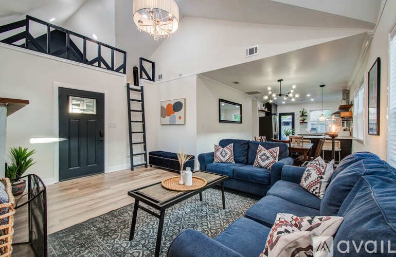 A living room with a blue couch and a coffee table.