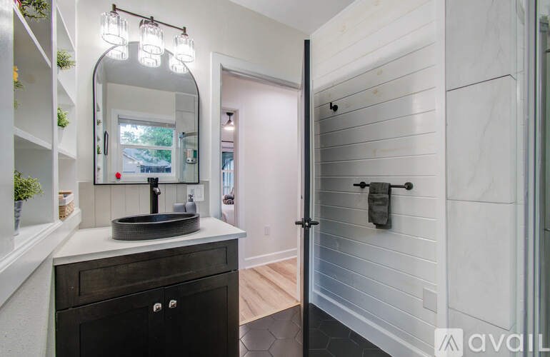 A bathroom with a vanity and a mirror.