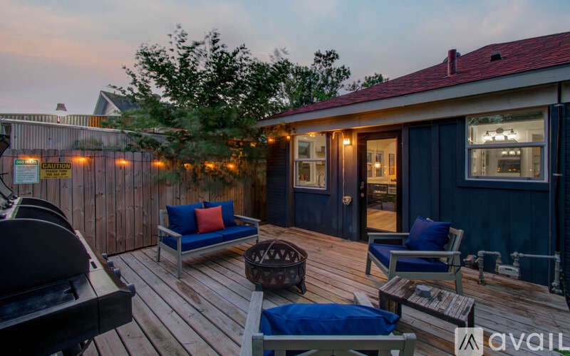 A deck with a table and chairs is surrounded by a fence.