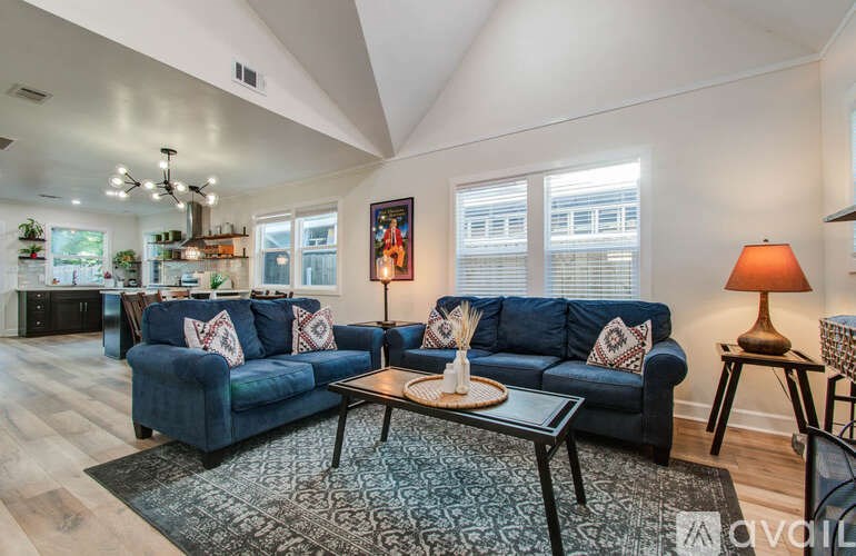 A living room with a blue couch and a coffee table.