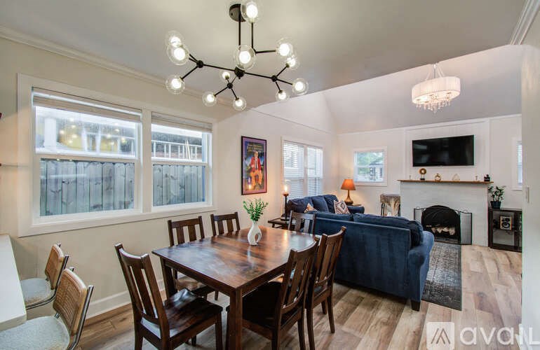A dining room with a wooden table and chairs.