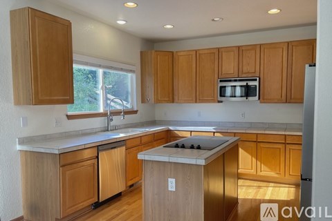 A kitchen with wooden cabinets and a white countertop.