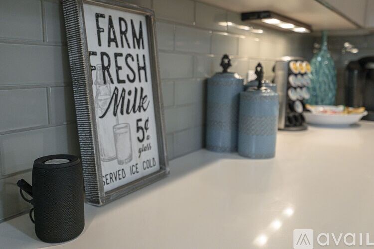 A sign advertising farm fresh milk sits on a counter.