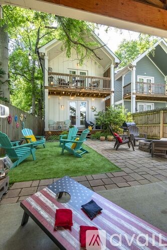 A backyard with a table and chairs and a flag on it.
