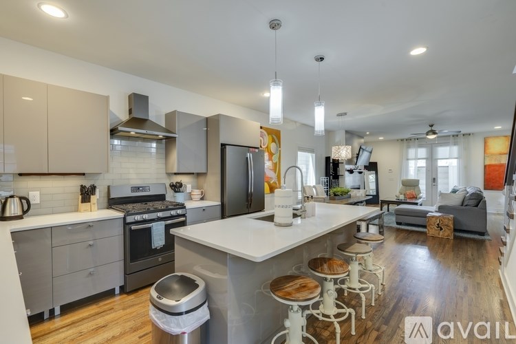A modern kitchen with a large island and stainless steel appliances.