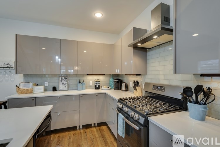A modern kitchen with a stove top oven and a range hood.