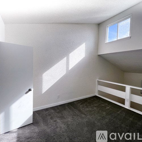 A room with a window and a door.