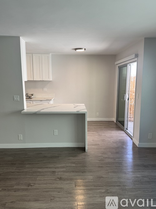 A kitchen area with a countertop and cabinets.