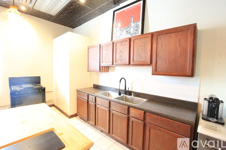 A kitchen with wooden cabinets and a black stove top oven.