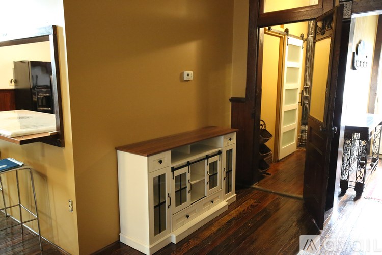A kitchen with a white cabinet and a brown counter top.
