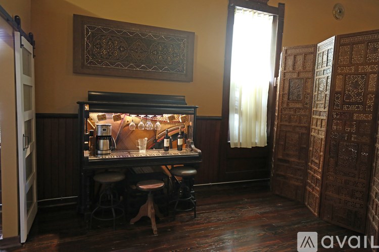 A room with a bar and a wooden floor.