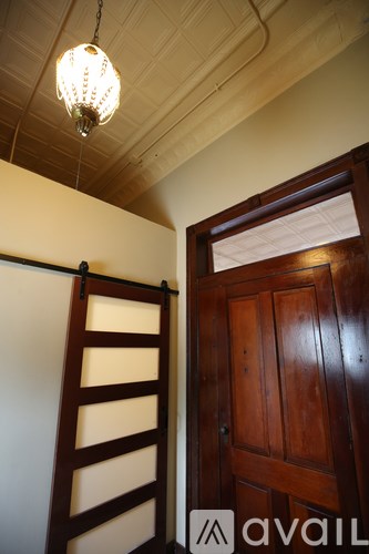 A wooden door is on the right and a wooden ladder is on the left.