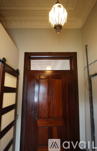 A wooden door with a glass window in the middle.