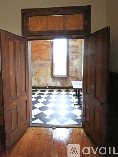 A room with a checkered floor and a window.