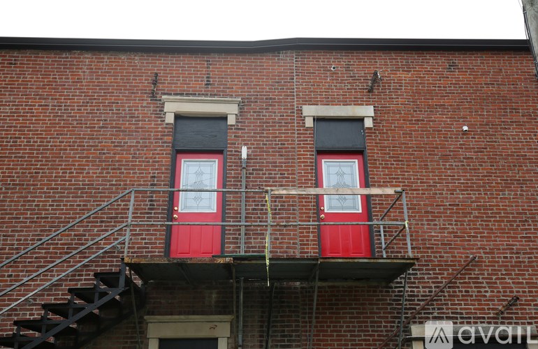 A red door with a window above it.