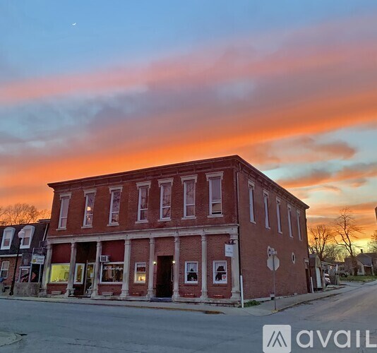 A red brick building with a white sign on the front.