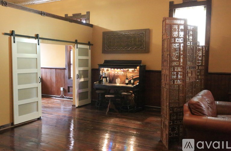 A room with a piano and a chair.