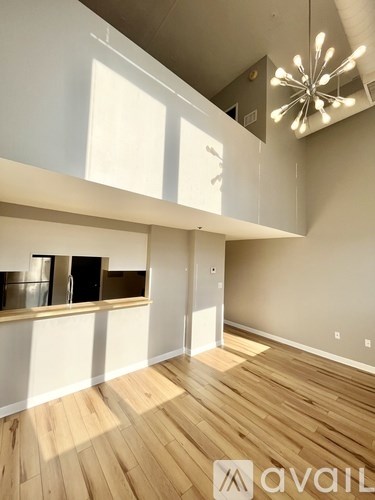 A room with wooden floors and a large window.