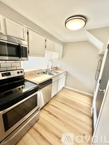 A kitchen with a stove top oven and microwave.