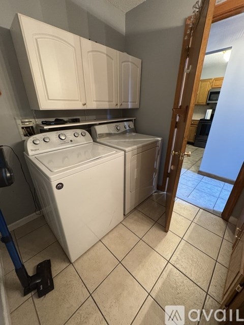 A white dishwasher and oven in a kitchen.