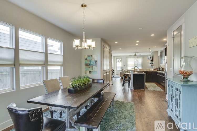 A modern dining room with a wooden table and chairs.