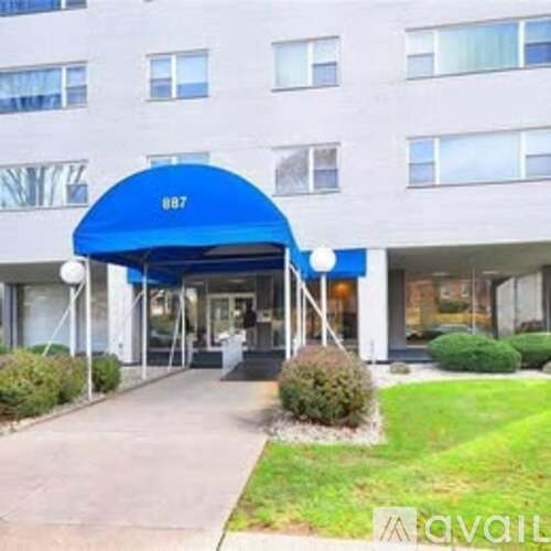 A building with a blue awning and the number 887 on it.