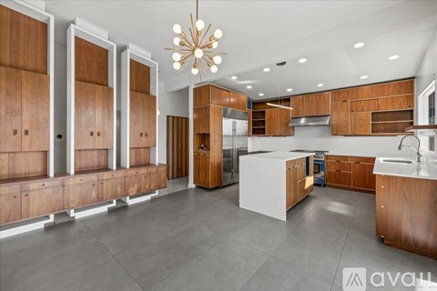 A modern kitchen with wooden cabinets and a central island.