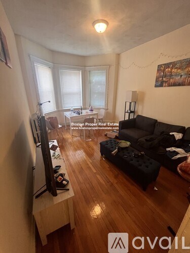 A living room with a television and a couch.