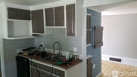 A kitchen with a sink and cabinets.