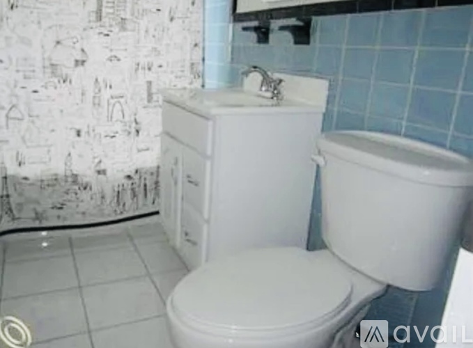 A white toilet and sink in a bathroom.